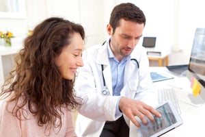 a doctor talks to a patient about improving the patient financial experience