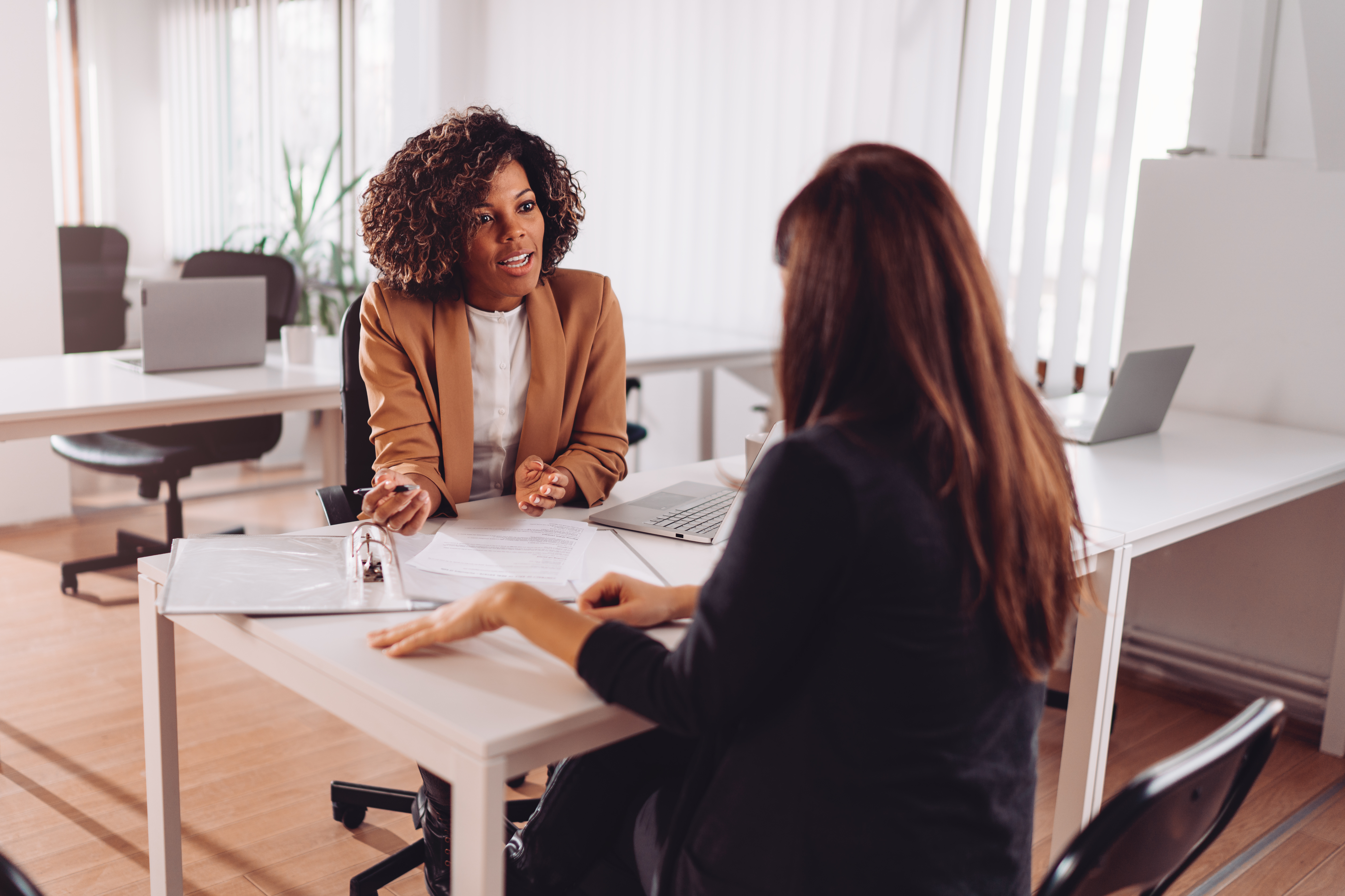 Woman explaining how a data admissions strategy means fewer patients lost  