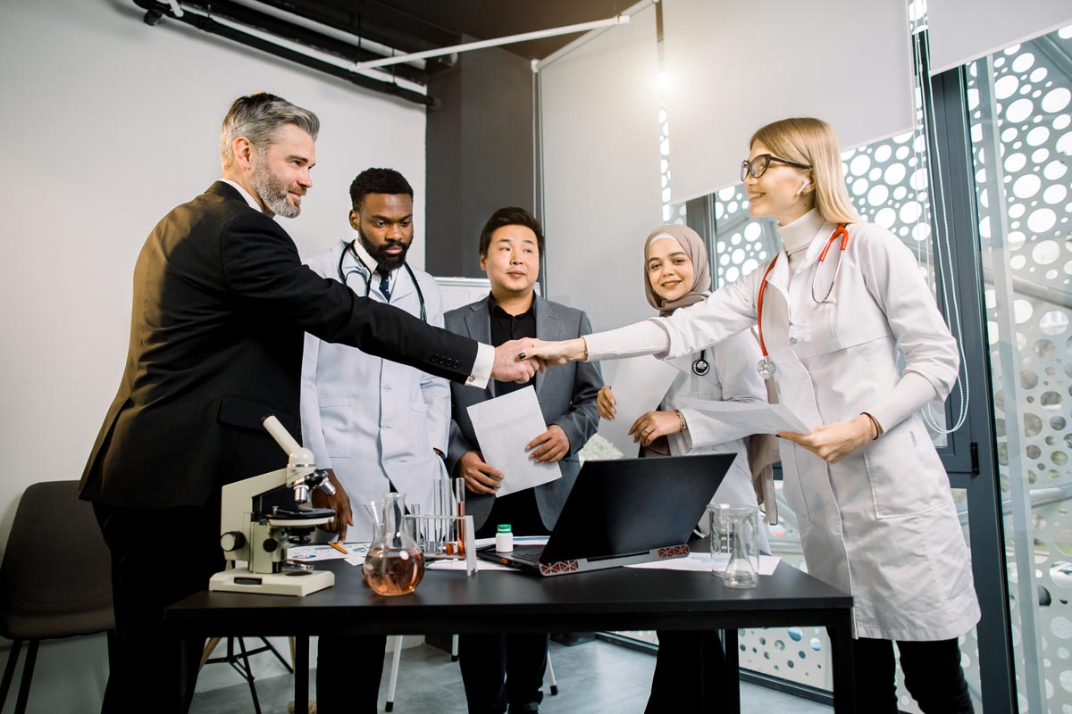 buseinessman shaking hands with female doctor discussing the healthcare experience