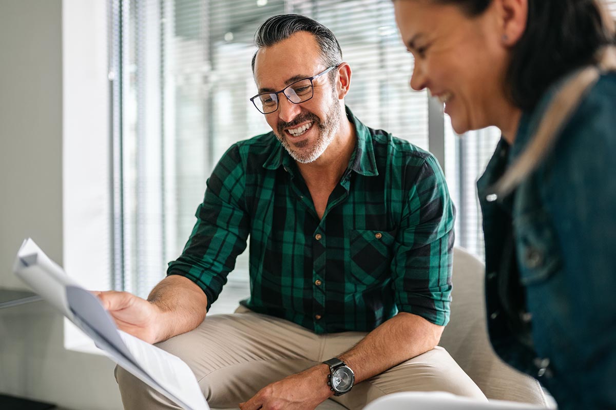 older man explaining what you should know about FinPay to smiling woman