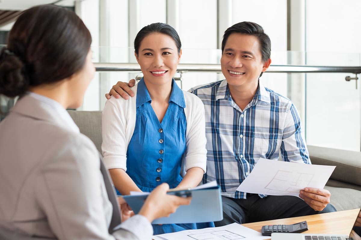 young couple talking to healthcare payment specialist